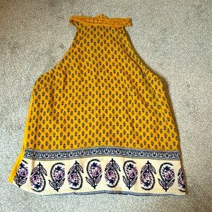 Cute patterned high neck sleeveless cami. Great for work, casual or night out!